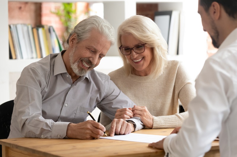 Older couple signing papers